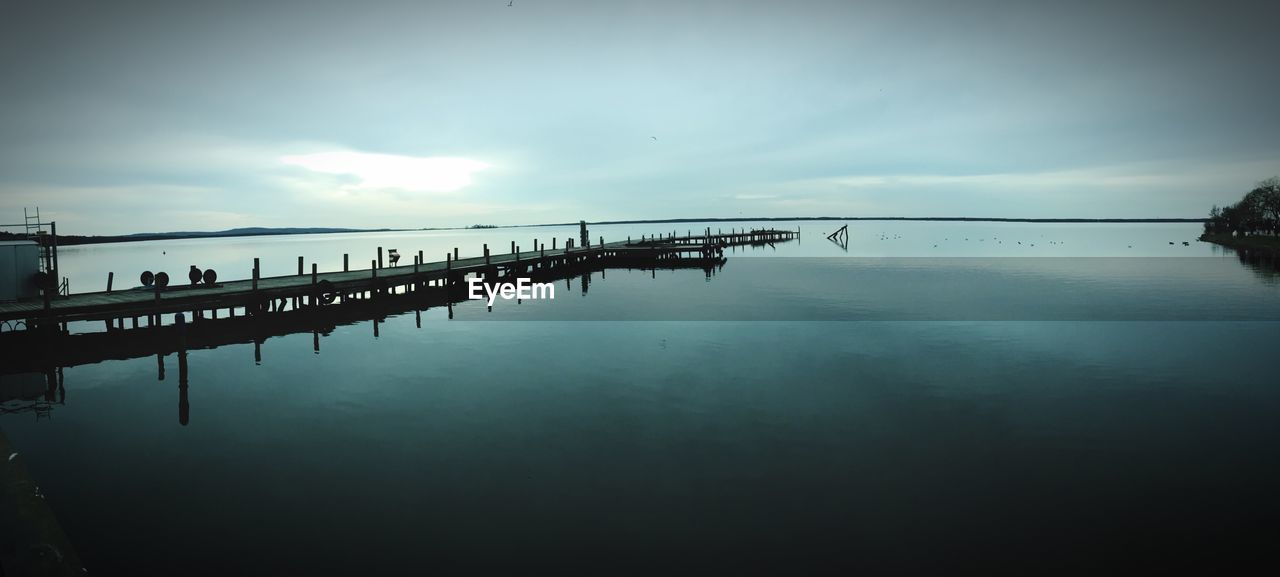 SILHOUETTE OF BRIDGE AGAINST SKY AT SUNSET