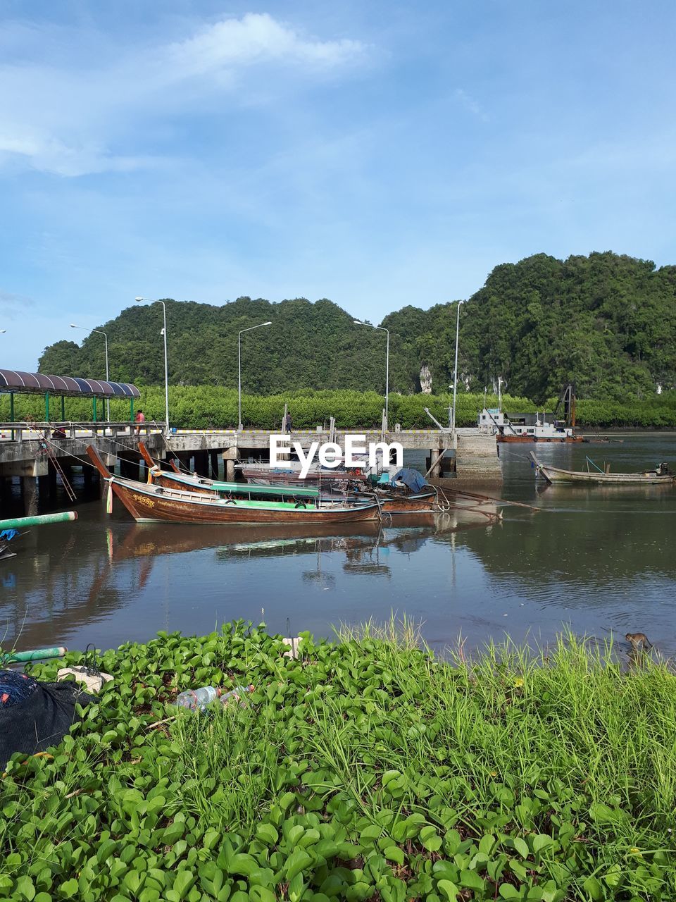 SAILBOATS MOORED IN WATER AGAINST SKY