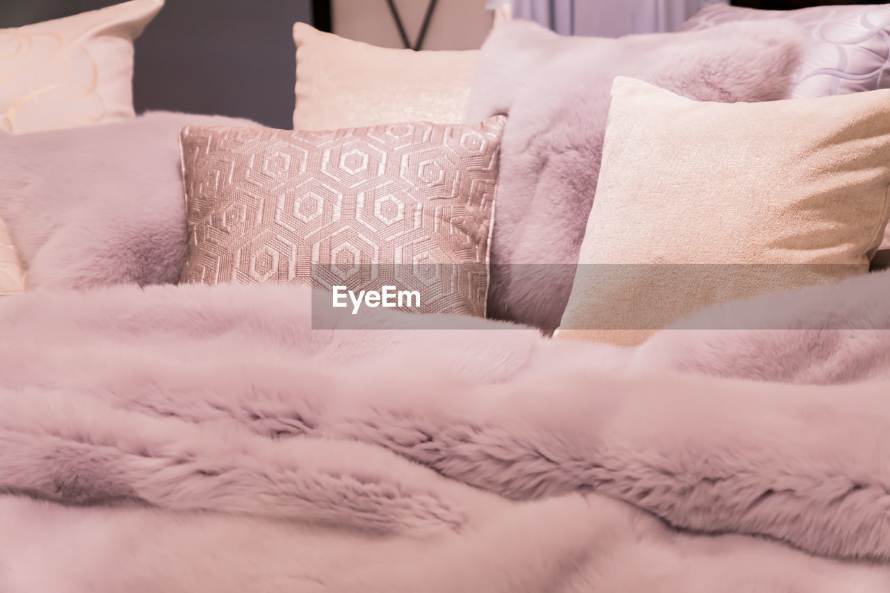 Pastep purple bedding - soft pillows and fur coverlet. coziness, comfort, interior  concept