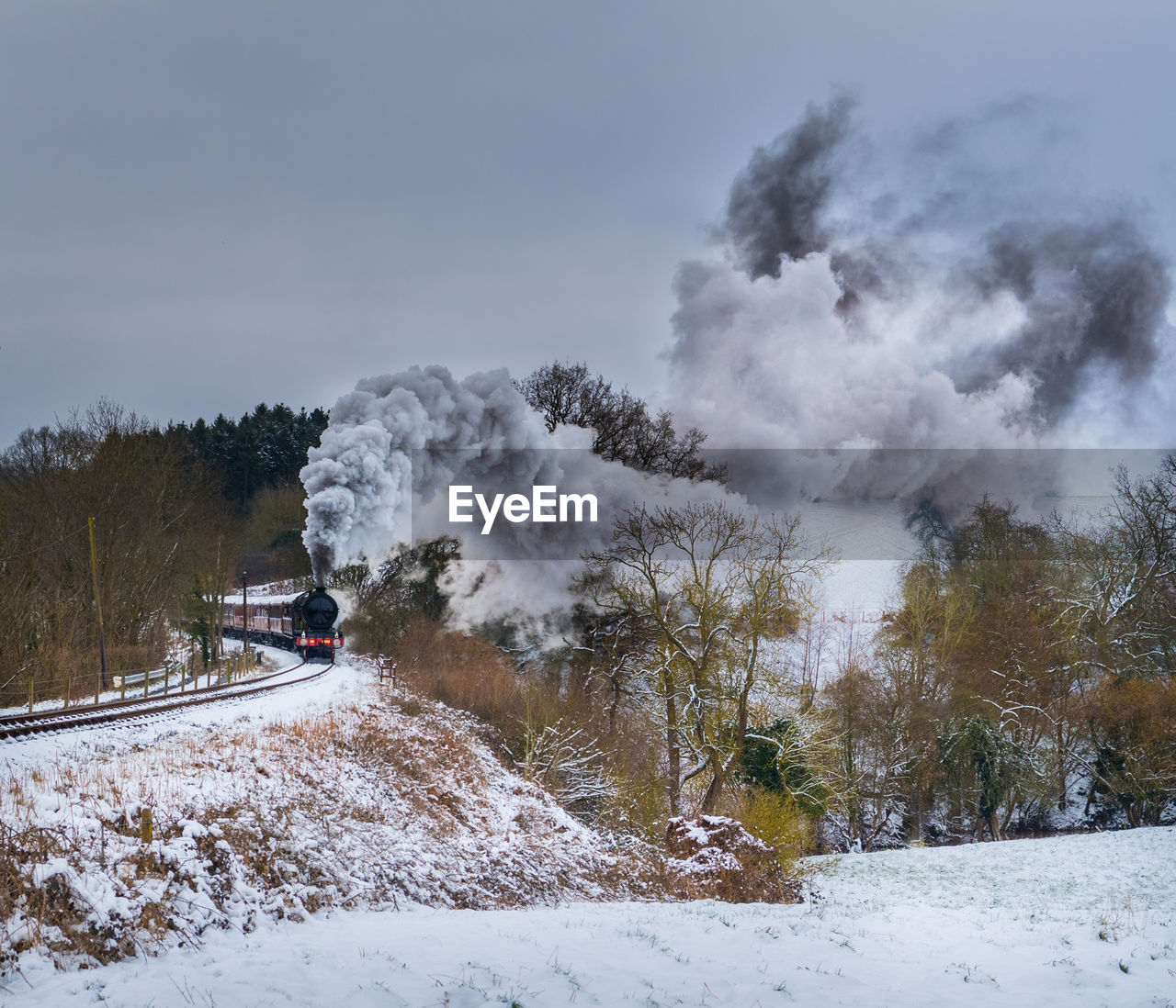 High angle view of steam train moving amidst landscape against sky