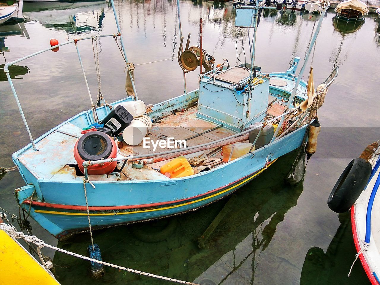 CLOSE-UP OF MOORED BOATS IN LAKE