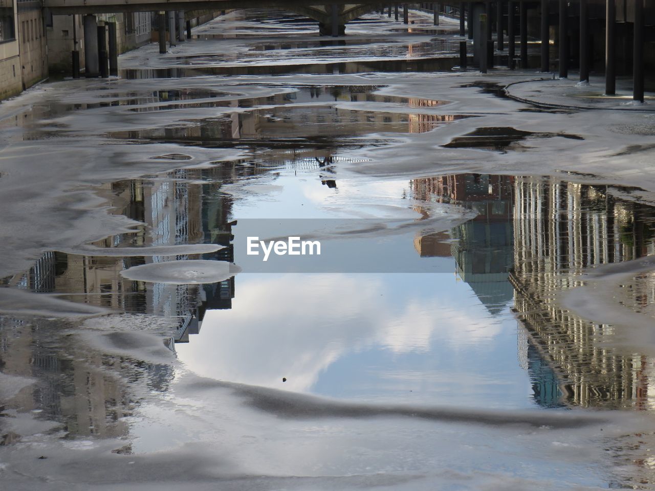 Reflection of frozen water in puddle