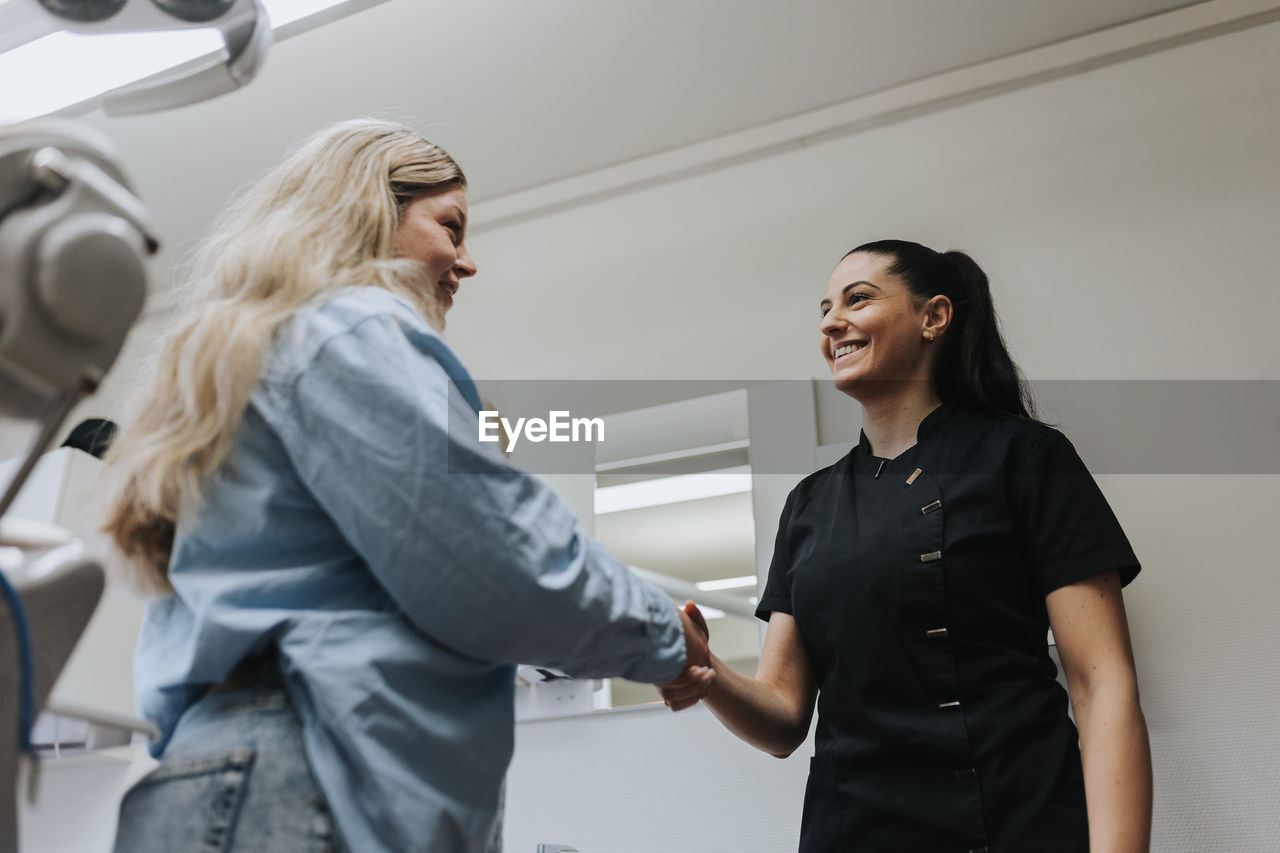 Female dentist with patient in dentist's office