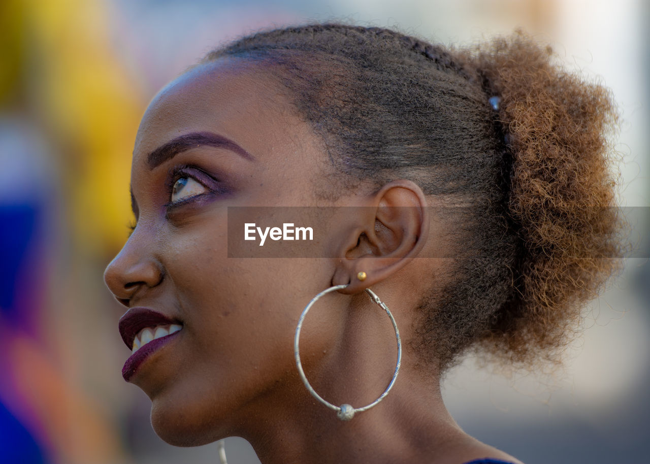 Close-up of thoughtful young woman wearing earring