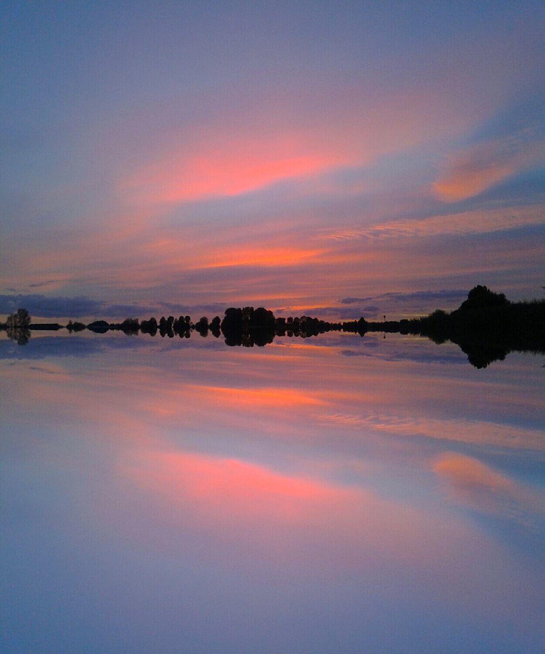 Idyllic shot of sunset sky reflection in lake