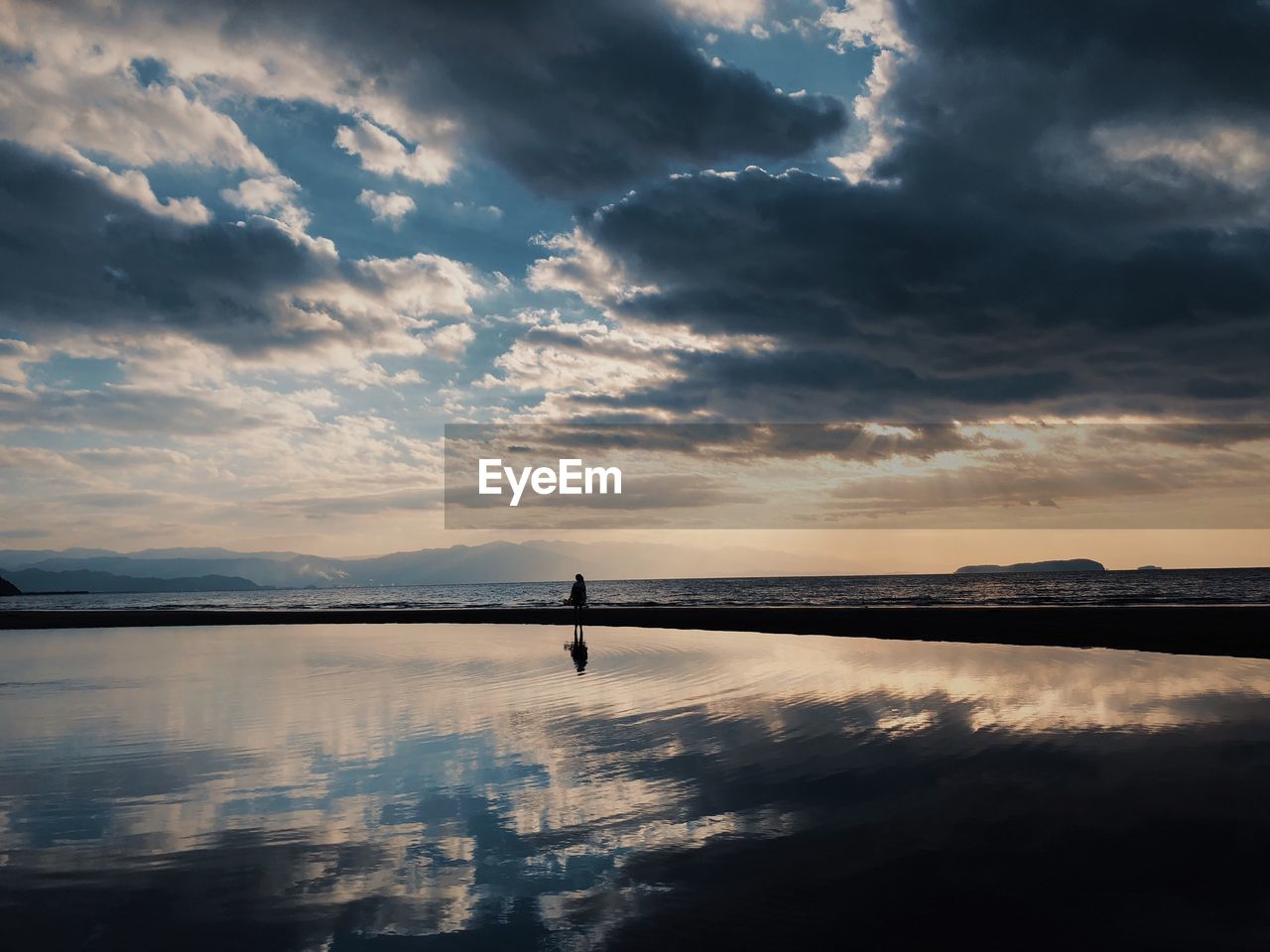 View of lake against cloudy sky