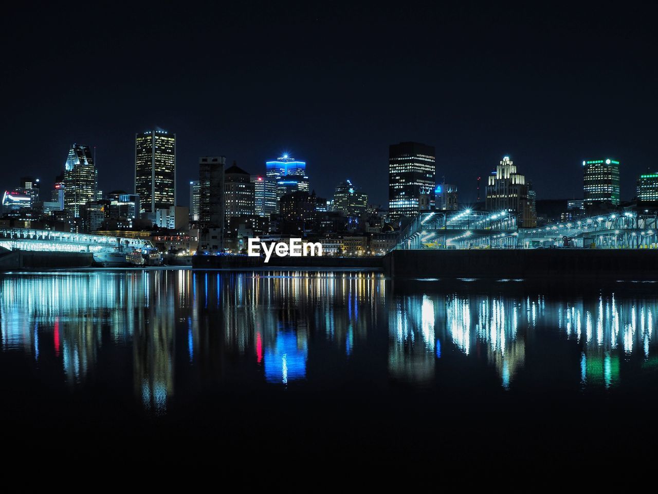 Reflection of illuminated buildings in river at night