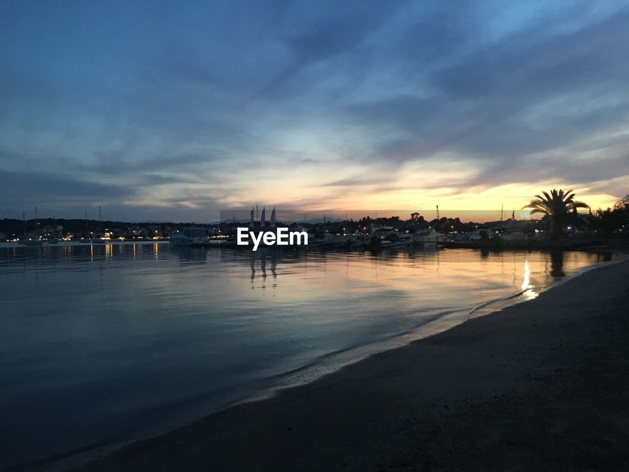 SCENIC VIEW OF BEACH AT SUNSET