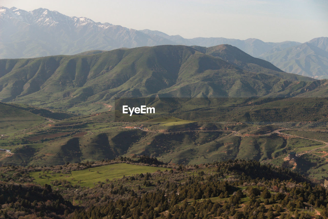 Scenic view of landscape and mountains against sky