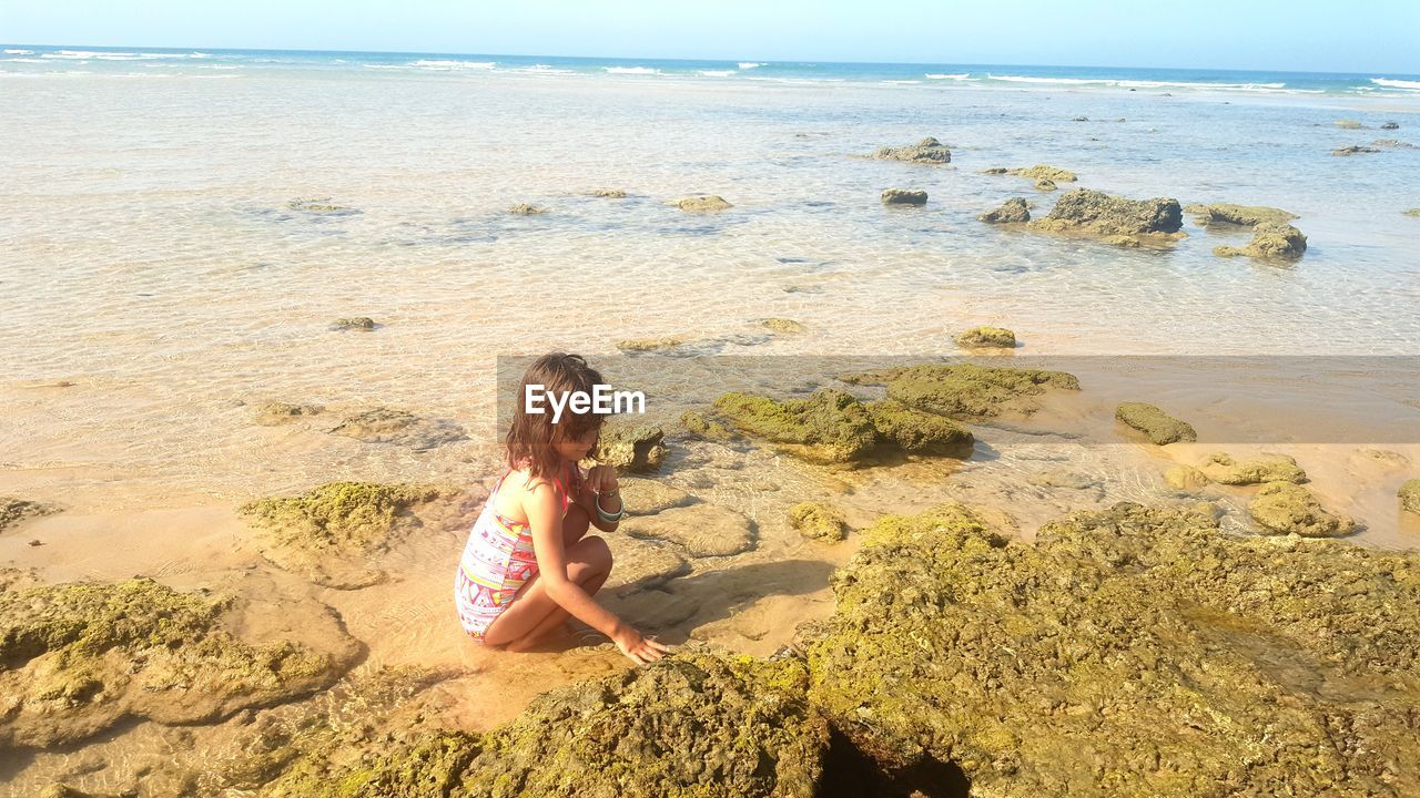 Girl playing on shore at beach