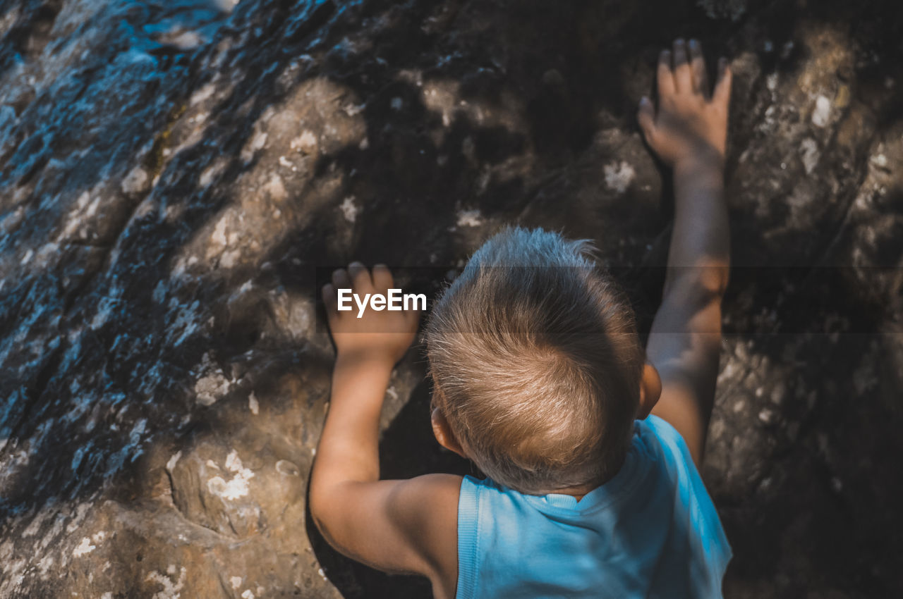 High angle view of boys on rock