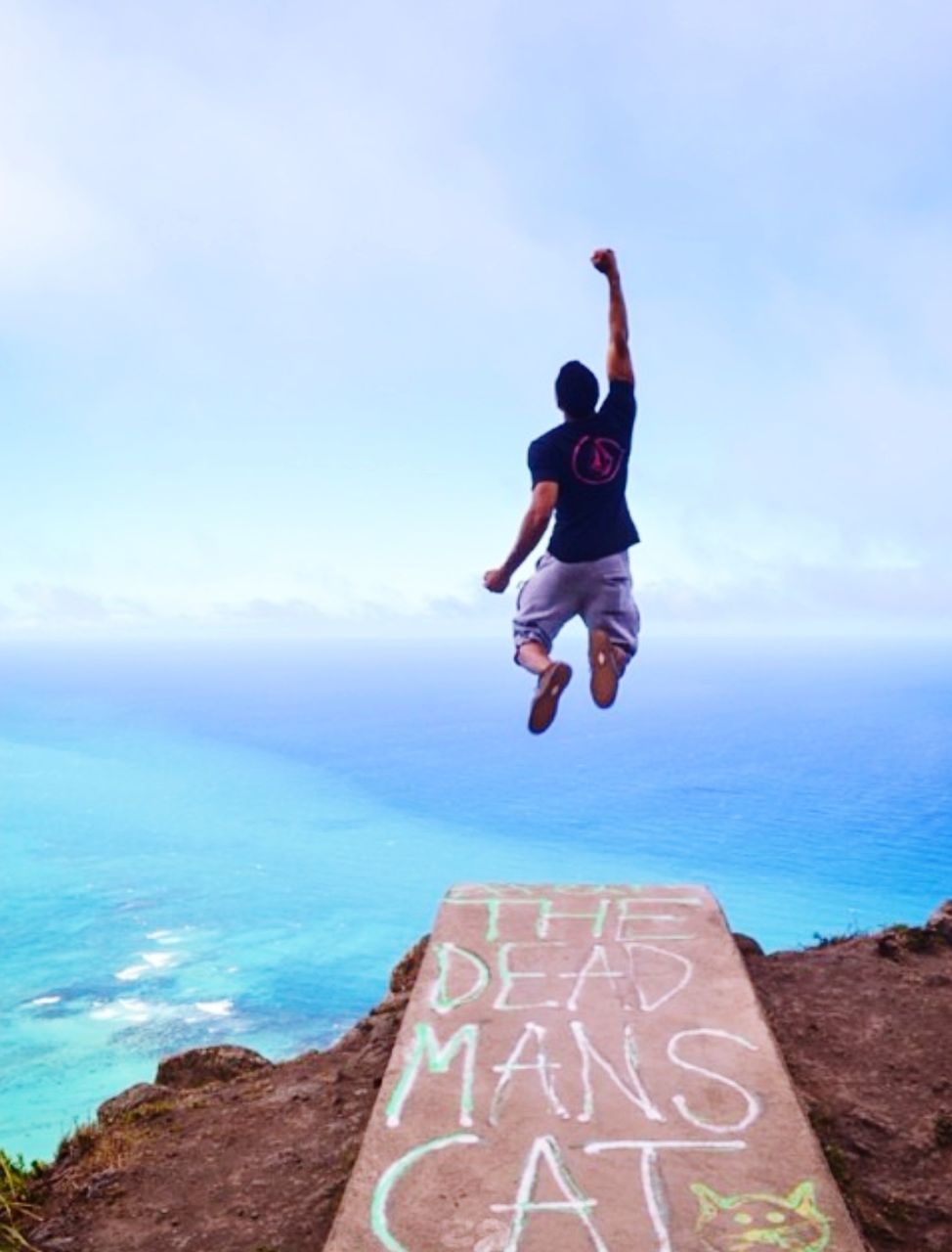 FULL LENGTH OF MAN JUMPING ON SEA AGAINST SKY