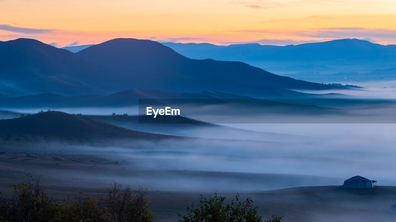 SCENIC VIEW OF MOUNTAINS DURING SUNSET