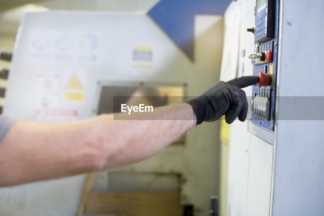 cropped hand of man working at home