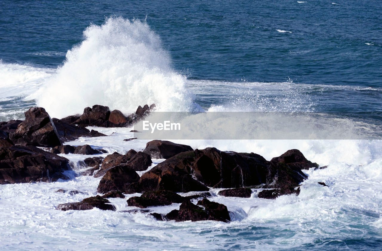 WAVES SPLASHING ON ROCK