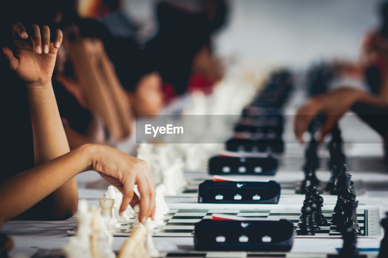 Close-up of hands playing chess