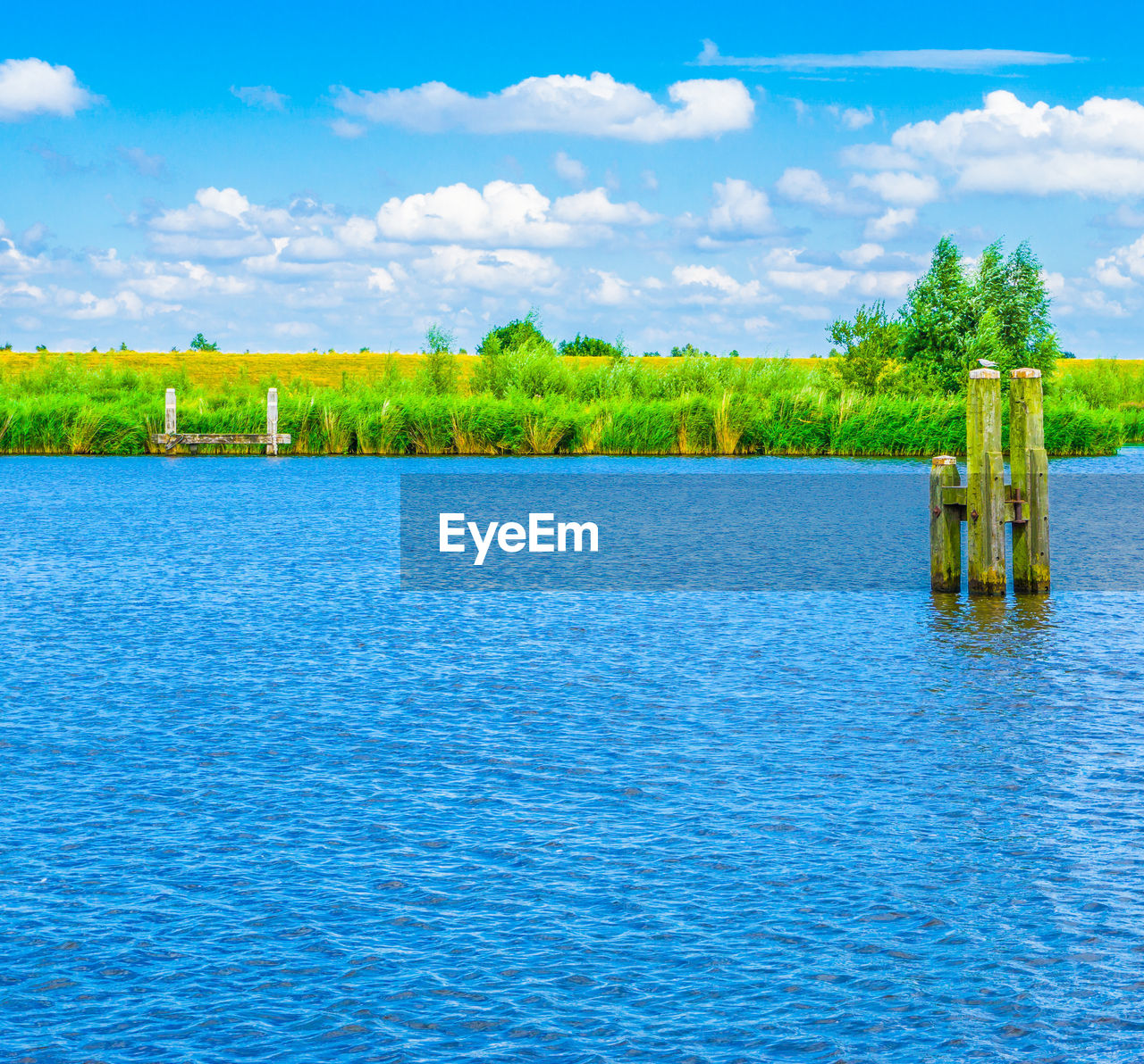 Scenic view of lake against blue sky