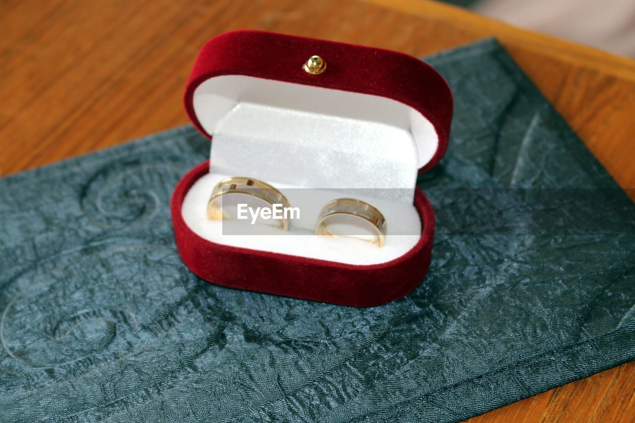 High angle view of wedding rings on table