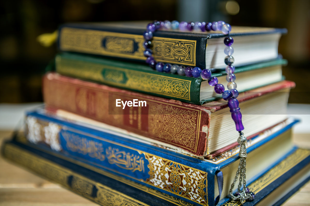 Stack of books with rosary beads
