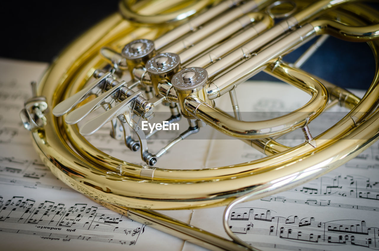 Close-up of trumpet on musical note