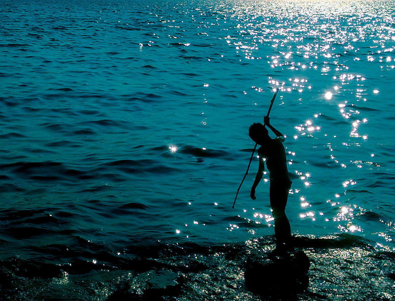 Boy fishing in sea