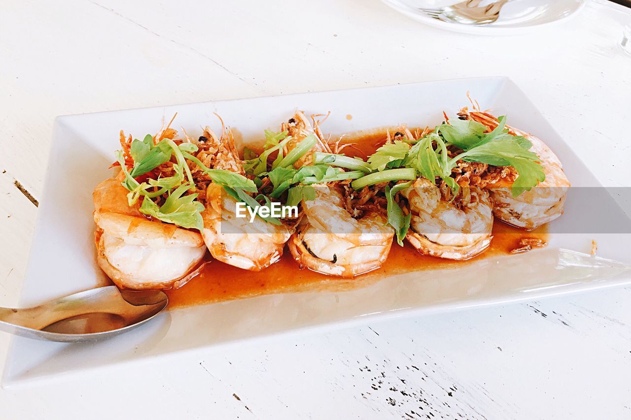 High angle view of vegetables in plate on table