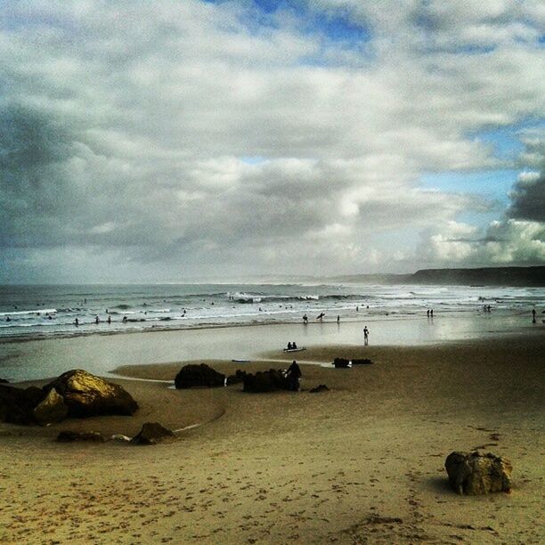 VIEW OF BEACH AGAINST CLOUDY SKY