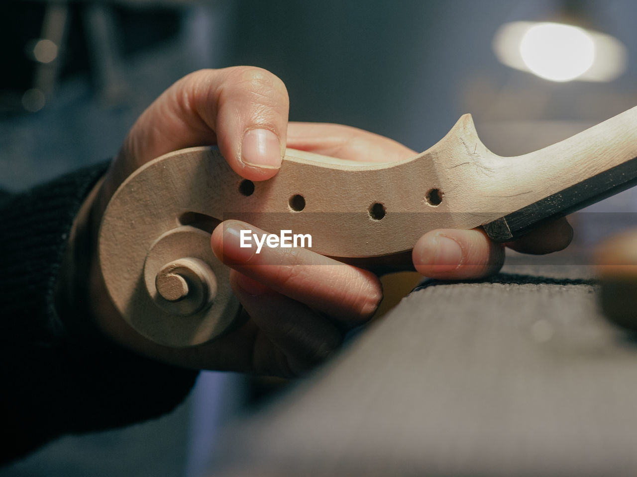 Luthier holding a classic violin scroll