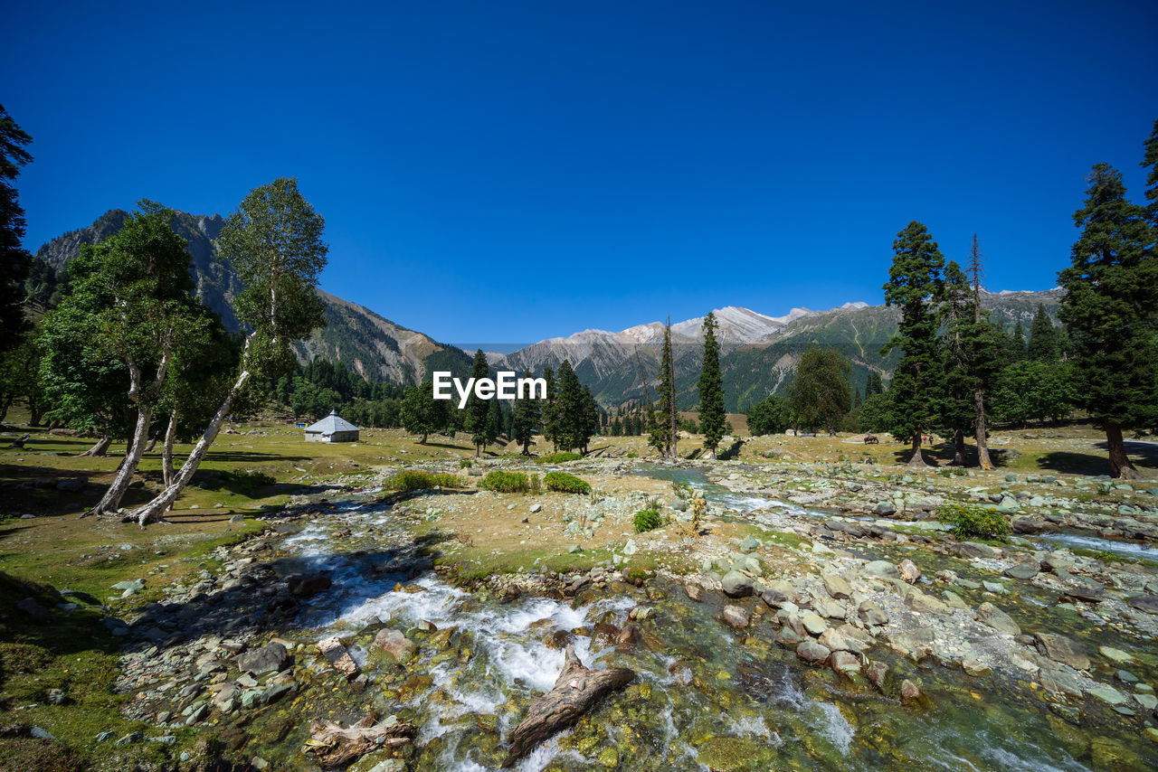 Scenic view of mountains against clear blue sky