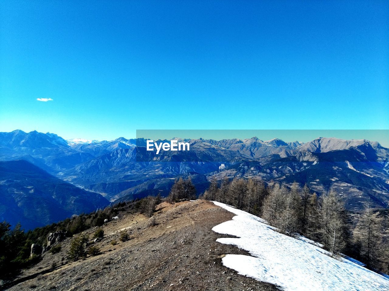 SNOWCAPPED MOUNTAINS AGAINST CLEAR BLUE SKY