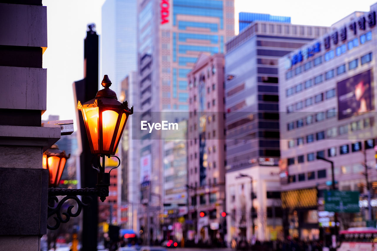 Illuminated street light in city at night