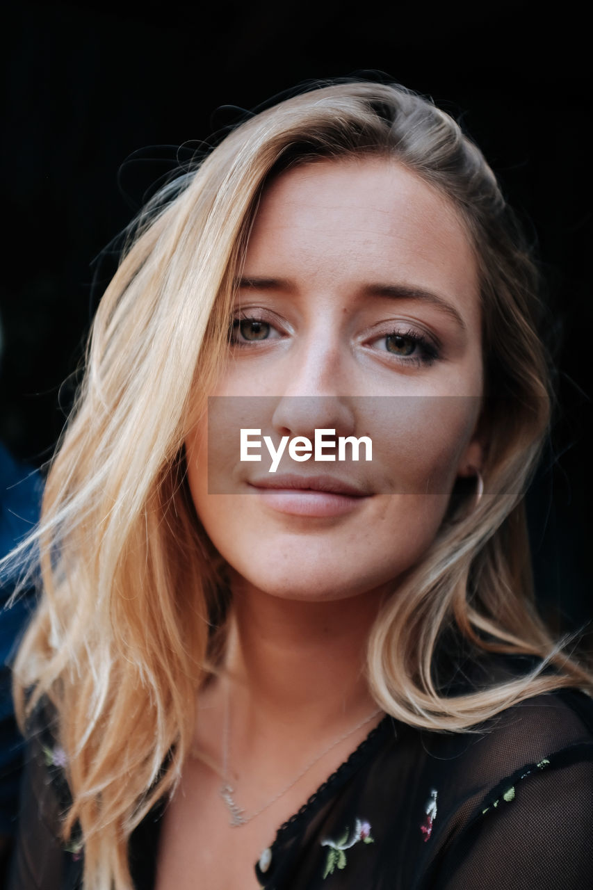 Close-up portrait of beautiful young woman in city