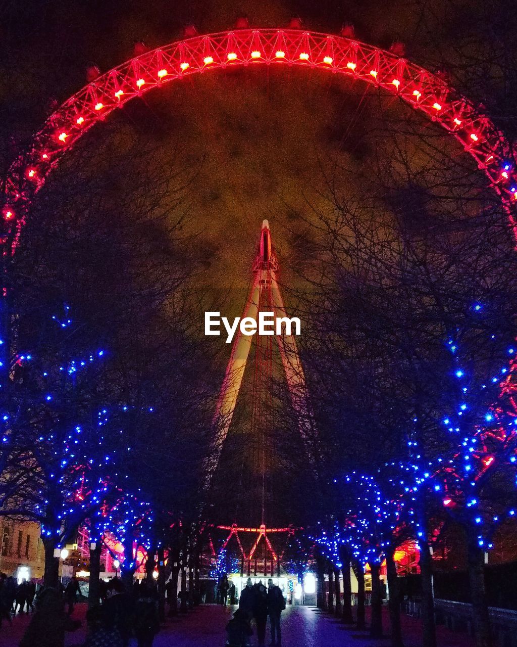 ILLUMINATED FERRIS WHEEL AGAINST SKY