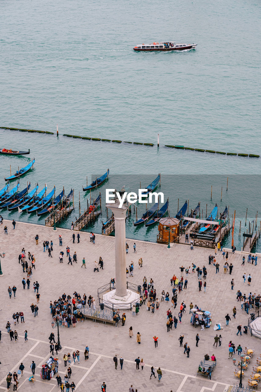 HIGH ANGLE VIEW OF PEOPLE ON BOATS