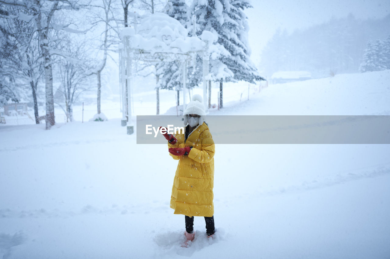 Full length of woman standing on snow