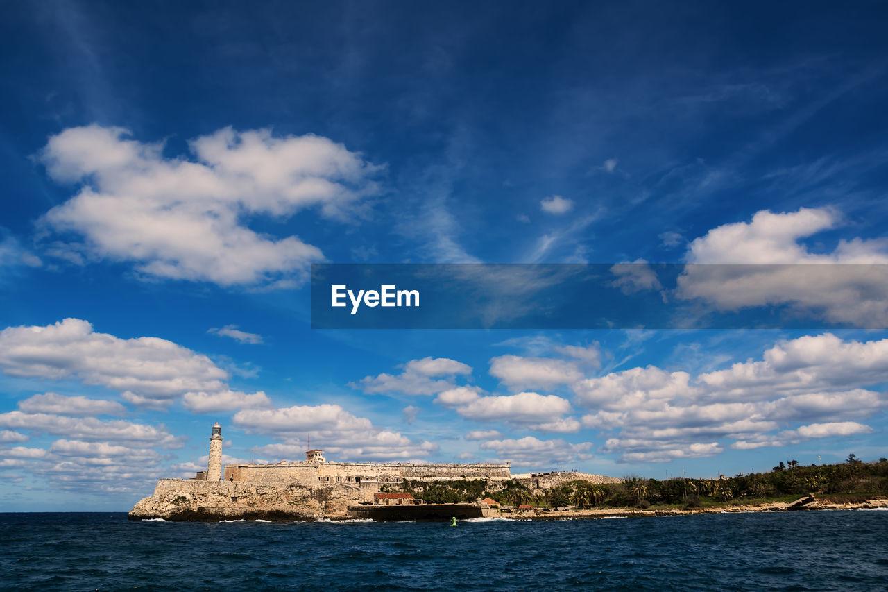 BUILDING BY SEA AGAINST SKY