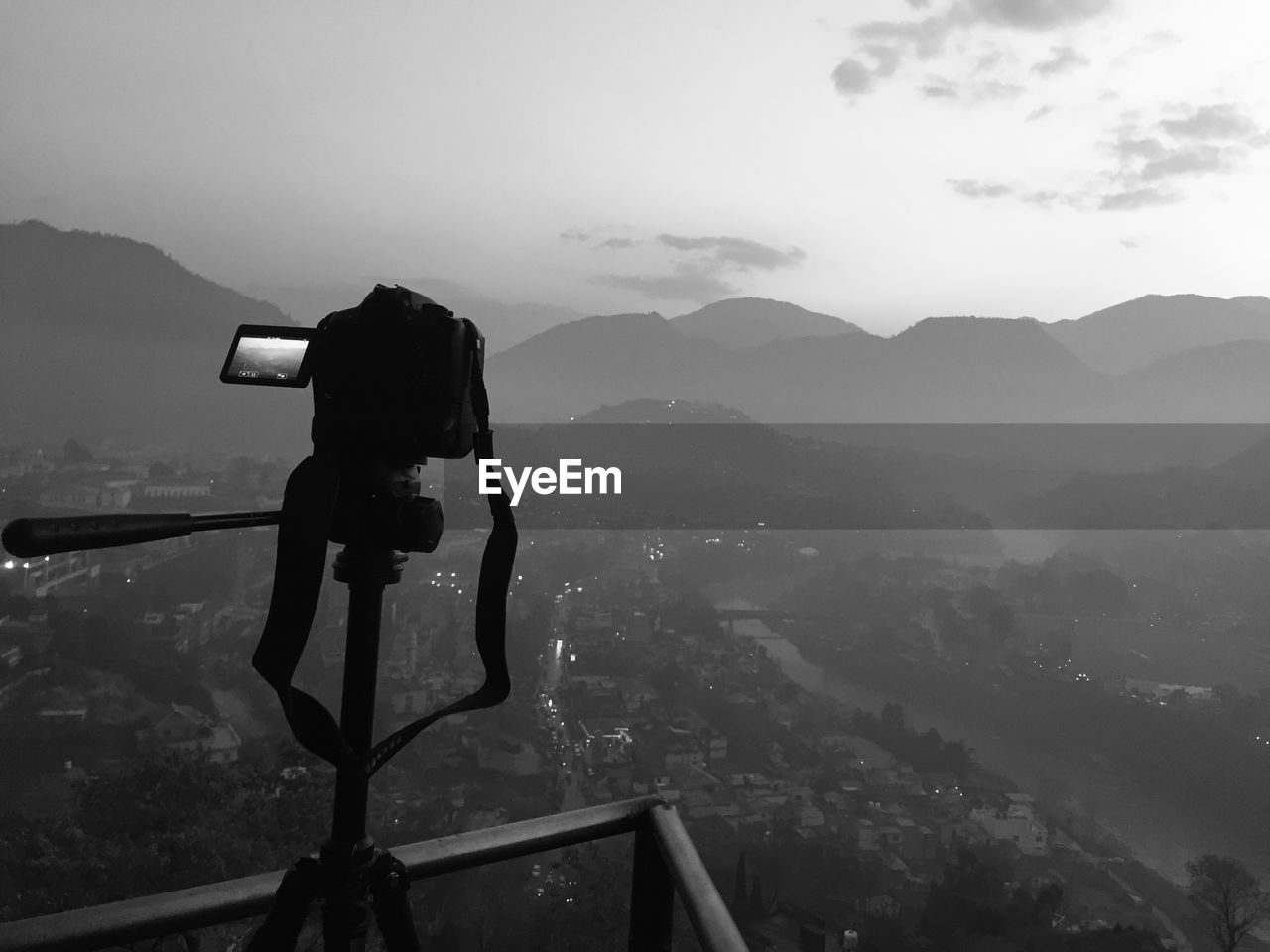 Man photographing on mountain against sky