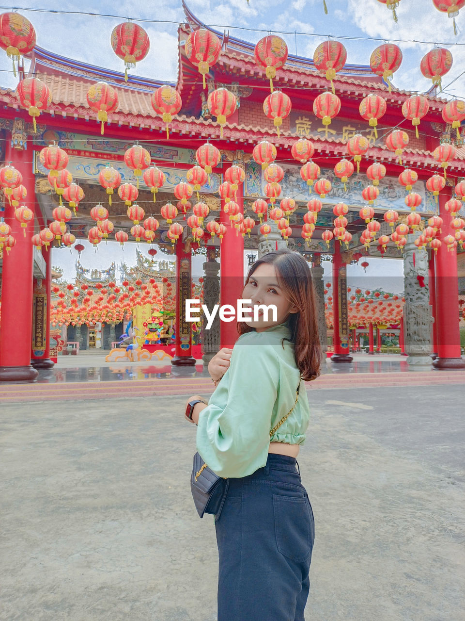 Rear view of young woman standing on street