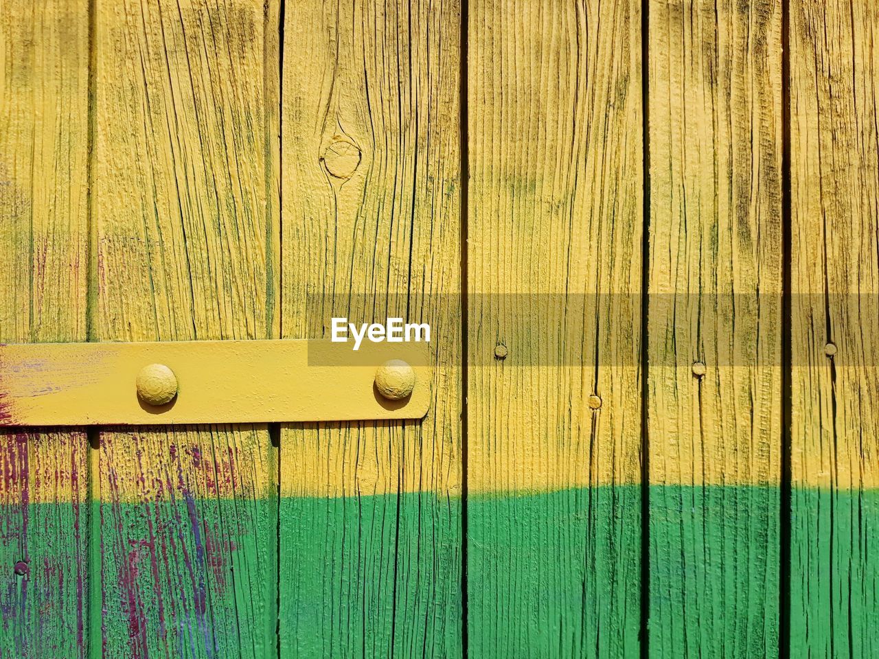 Full frame shot of yellow and green colored wood paneling