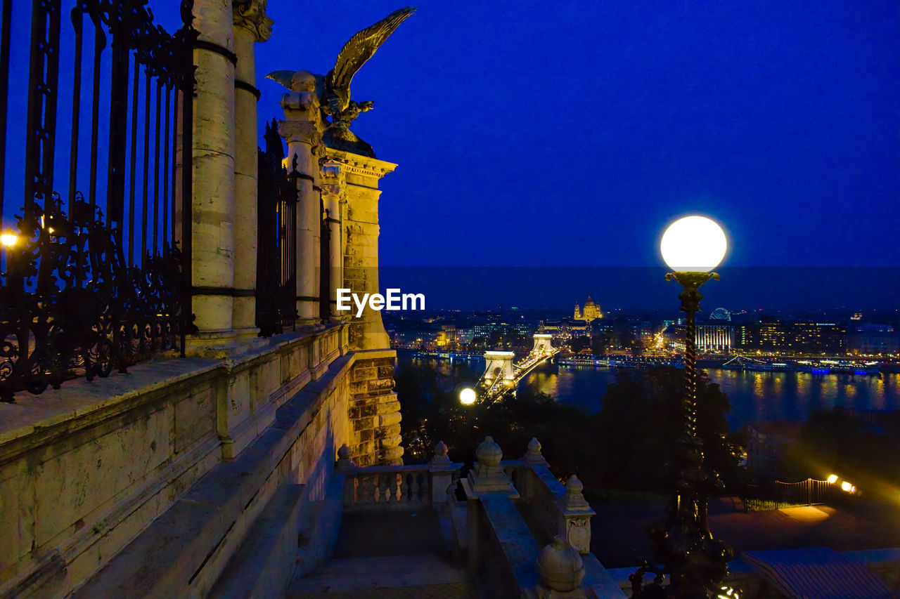 Illuminated city and danube river against sky seen from buda castle