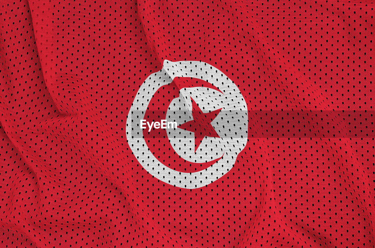 HIGH ANGLE VIEW OF TEXT ON RED FABRIC