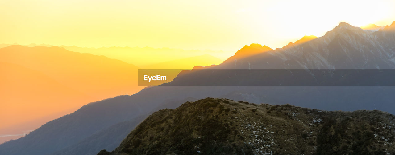 Scenic view of mountains against sky during sunset