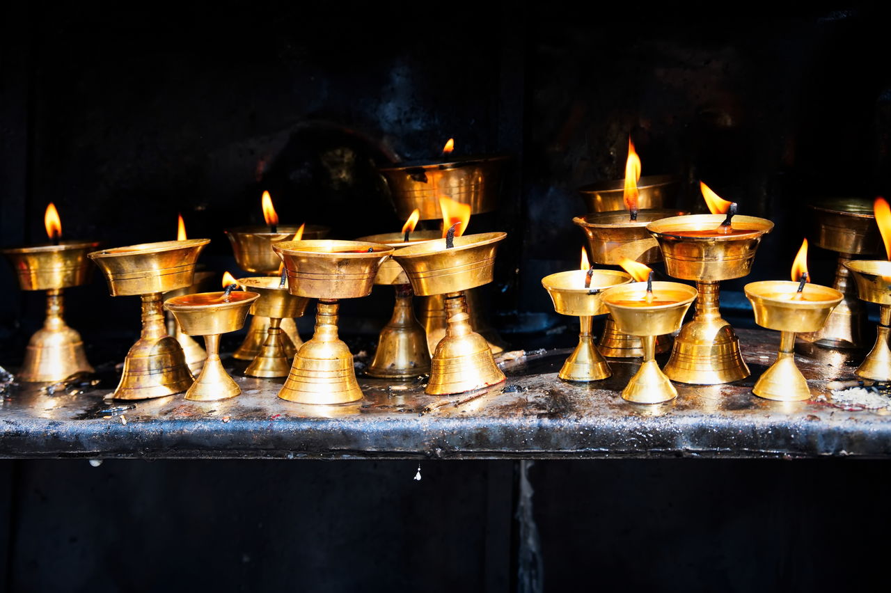 Nepalese candles lighting a temple wall