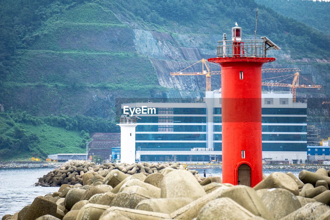 LIGHTHOUSE ON BEACH BY SEA