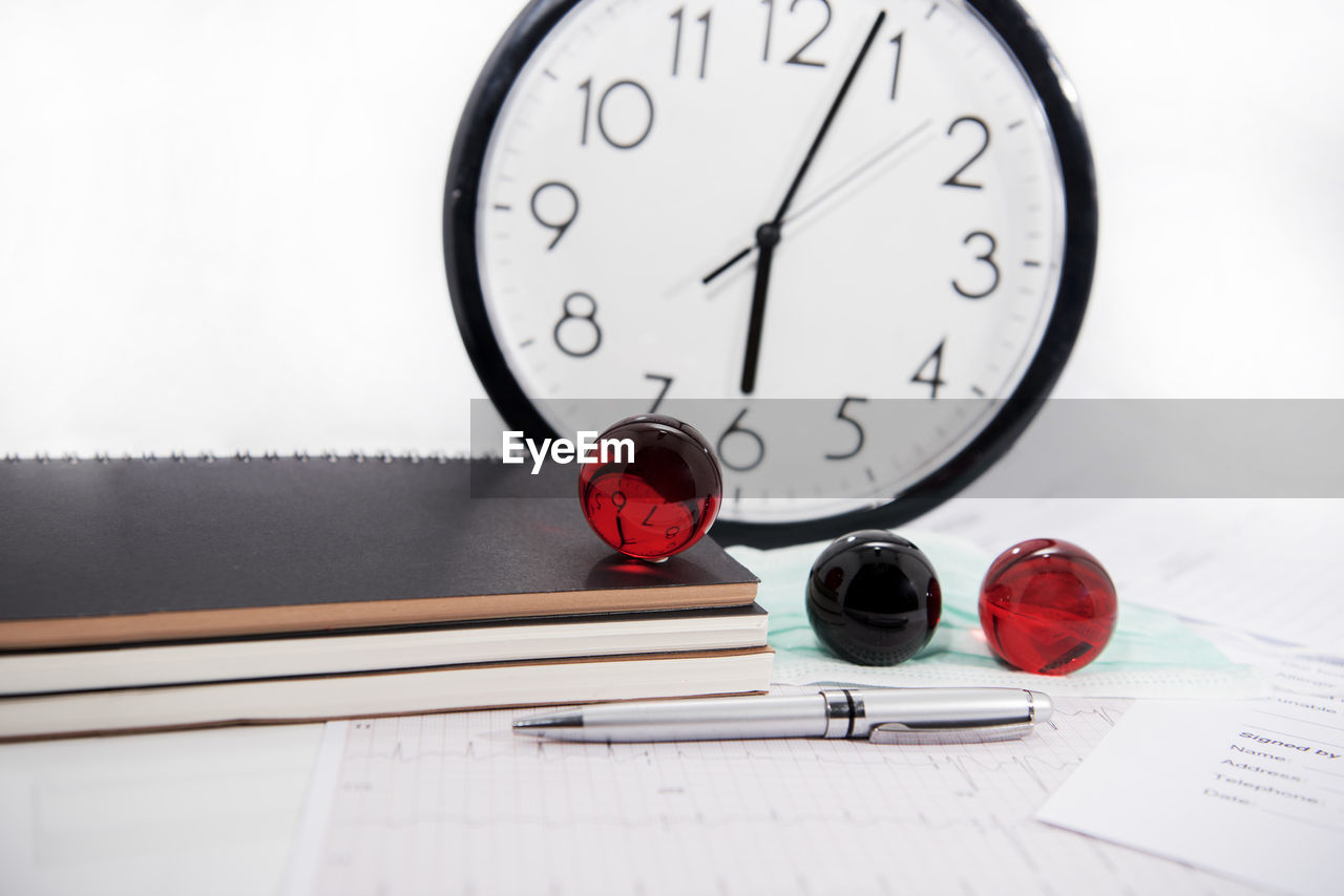 CLOSE-UP OF CLOCK ON TABLE AT HOME