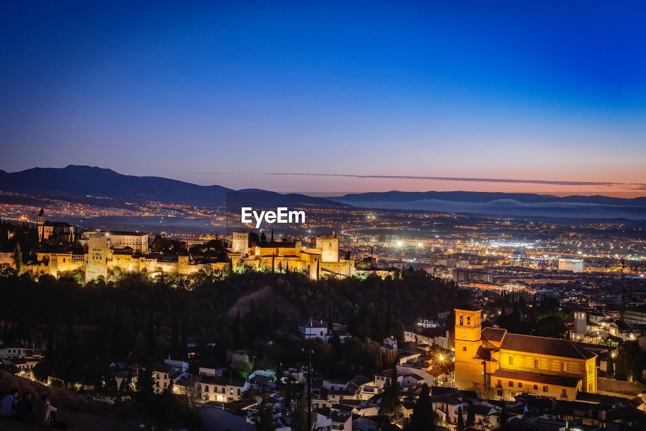 High angle view of illuminated city against sky at night. alhambra