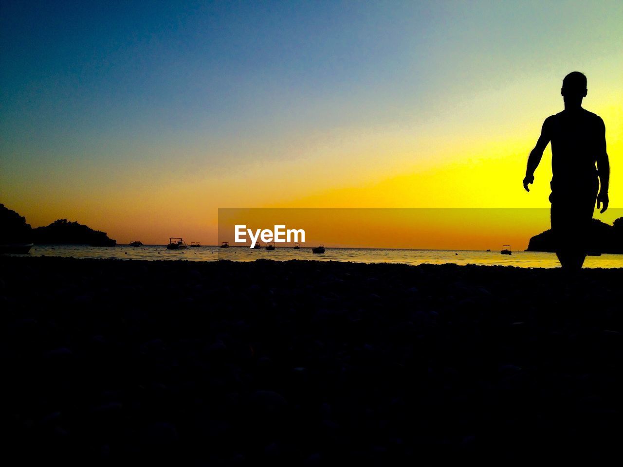 SILHOUETTE MAN AT BEACH DURING SUNSET