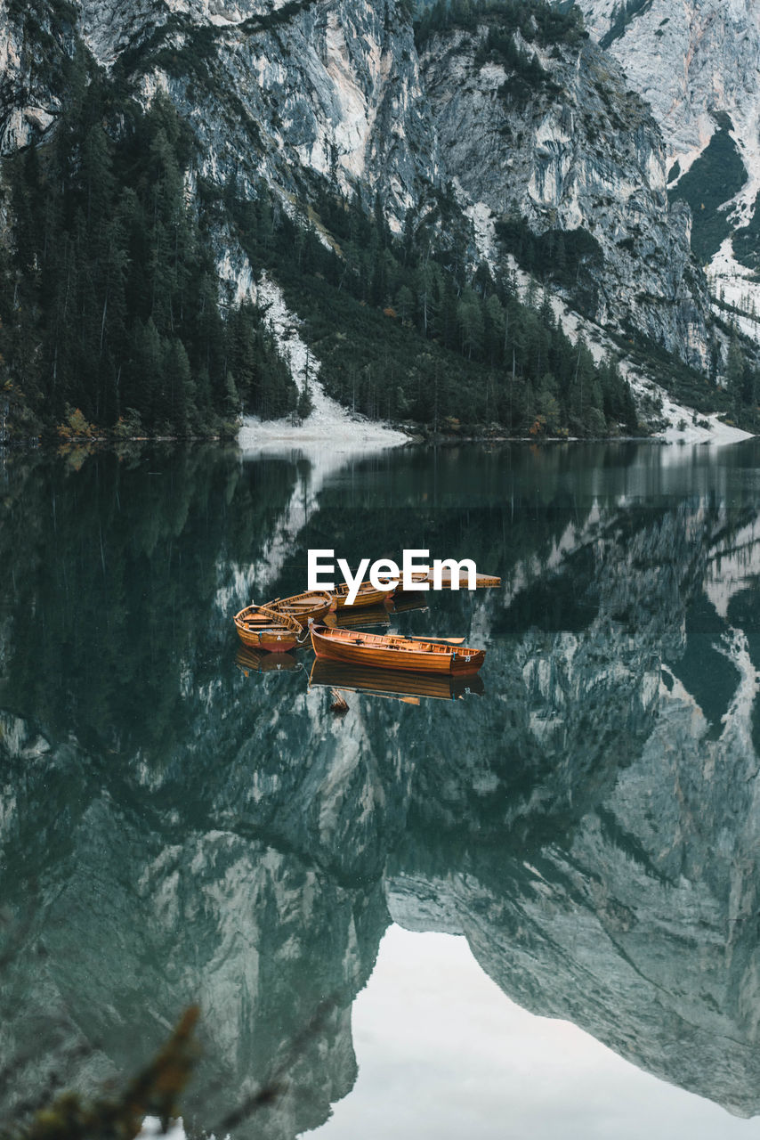 High angle view of boats on lake against mountains