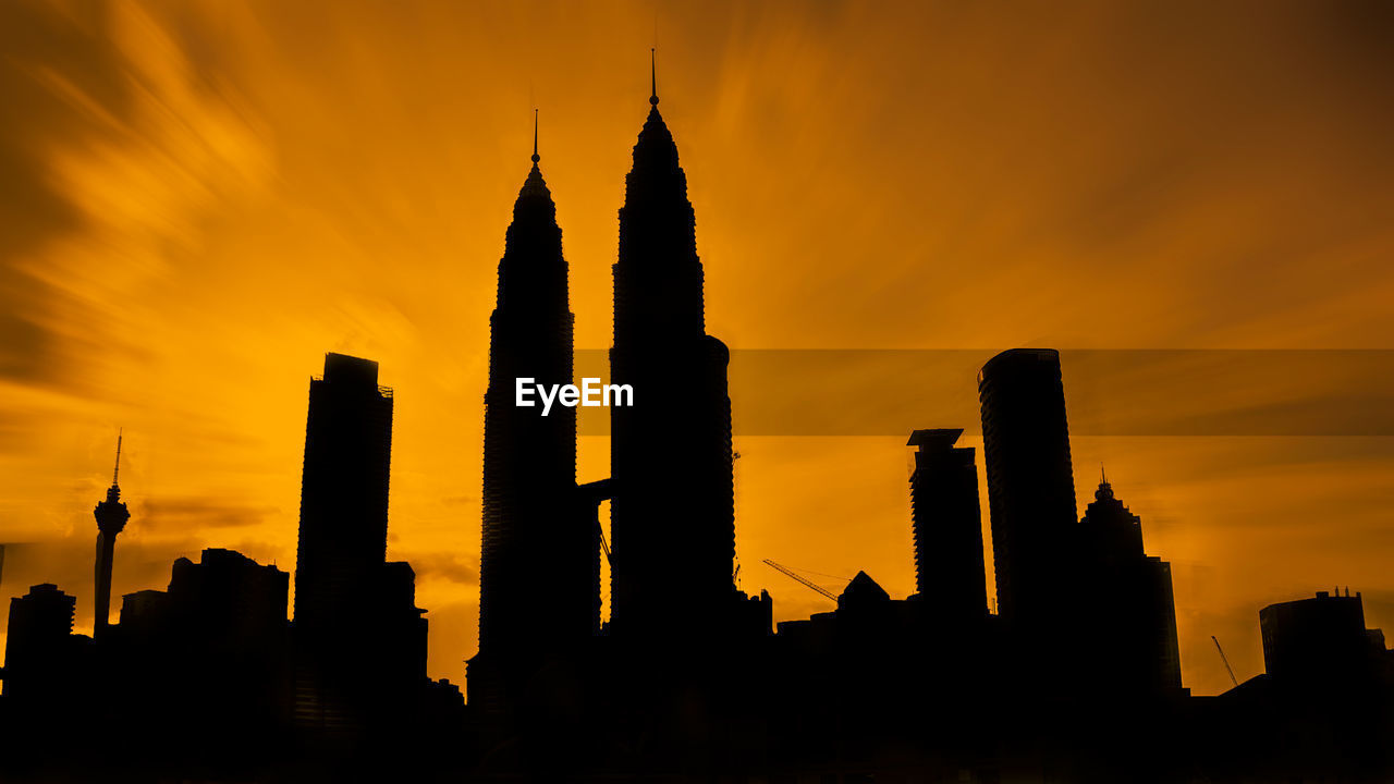 Low angle view of silhouette buildings against sky during sunset