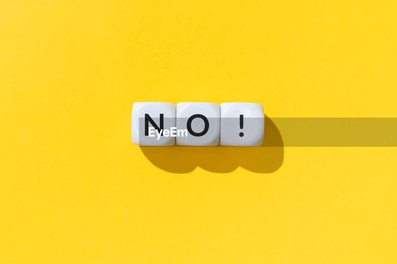 No word on white cube blocks isolated on yellow background